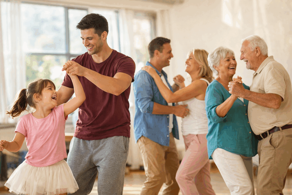 Bambina, giovane adulto e coppia di anziani che ballano insieme in una sala luminosa con luce naturale, esempio dei benefici della danza per corpo e mente a tutte le età